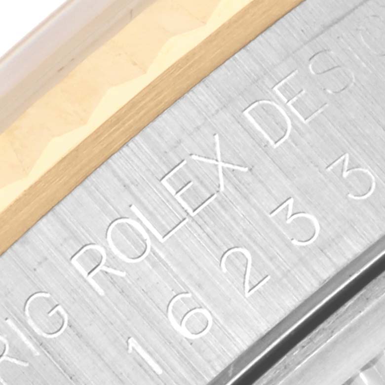 The image shows a close-up of the engraved side view of a Rolex Datejust 16233 Men
s Steel and Gold (two tone) White Dial 16233 Men
s Steel and Gold (two tone) White Dial watch case, highlighting the brand and design details.