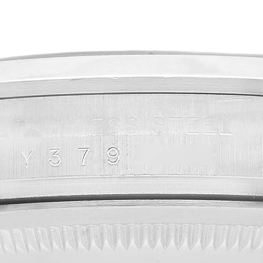 This image shows a close-up of the serial number and stainless steel marking on the bezel of a Rolex Explorer 114270 Men's Stainless Steel Black Dial 114270 Men's Stainless Steel Black Dial watch.