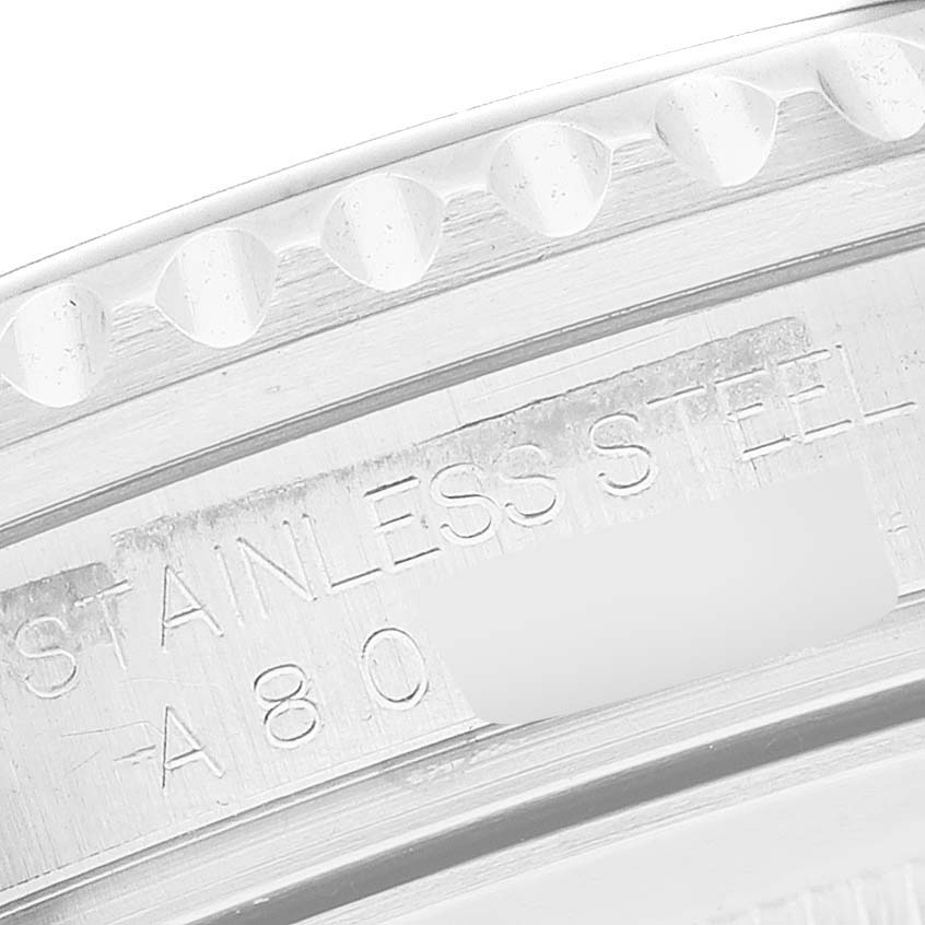 This image shows a close-up of the stainless steel engraving and bezel of a Rolex GMT-Master 16710 Men's Stainless Steel Black Dial 16710 Men's Stainless Steel Black Dial watch.