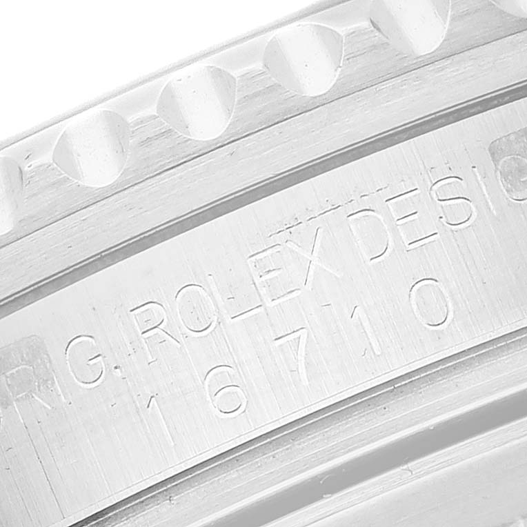This image shows a close-up view of the engraving on the case of a Rolex GMT-Master 16710 Men's Stainless Steel Black Dial 16710 Men's Stainless Steel Black Dial watch.