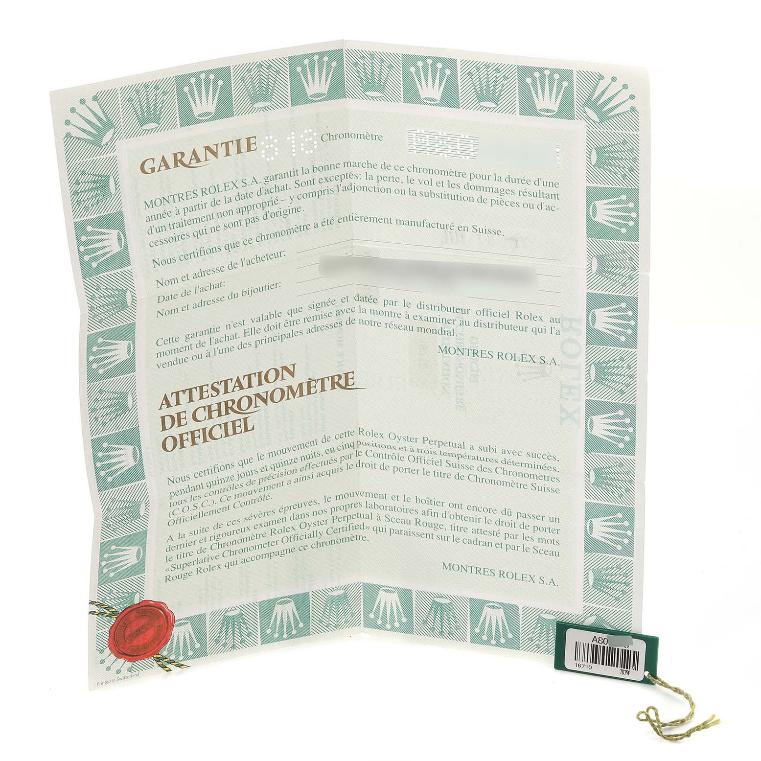 The image shows a Rolex warranty certificate and a green serial tag for the Rolex GMT-Master 16710 Men's Stainless Steel Black Dial 16710 Men's Stainless Steel Black Dial model.