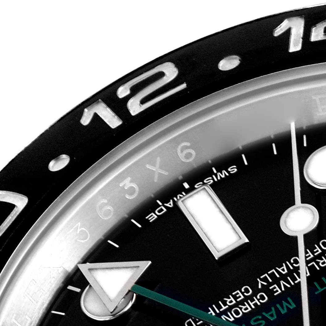 The image shows a close-up of the Rolex GMT-Master 116710 Men
s Stainless Steel Black Dial 116710 Men
s Stainless Steel Black Dial watch, focusing on the bezel, markers, and part of the dial.