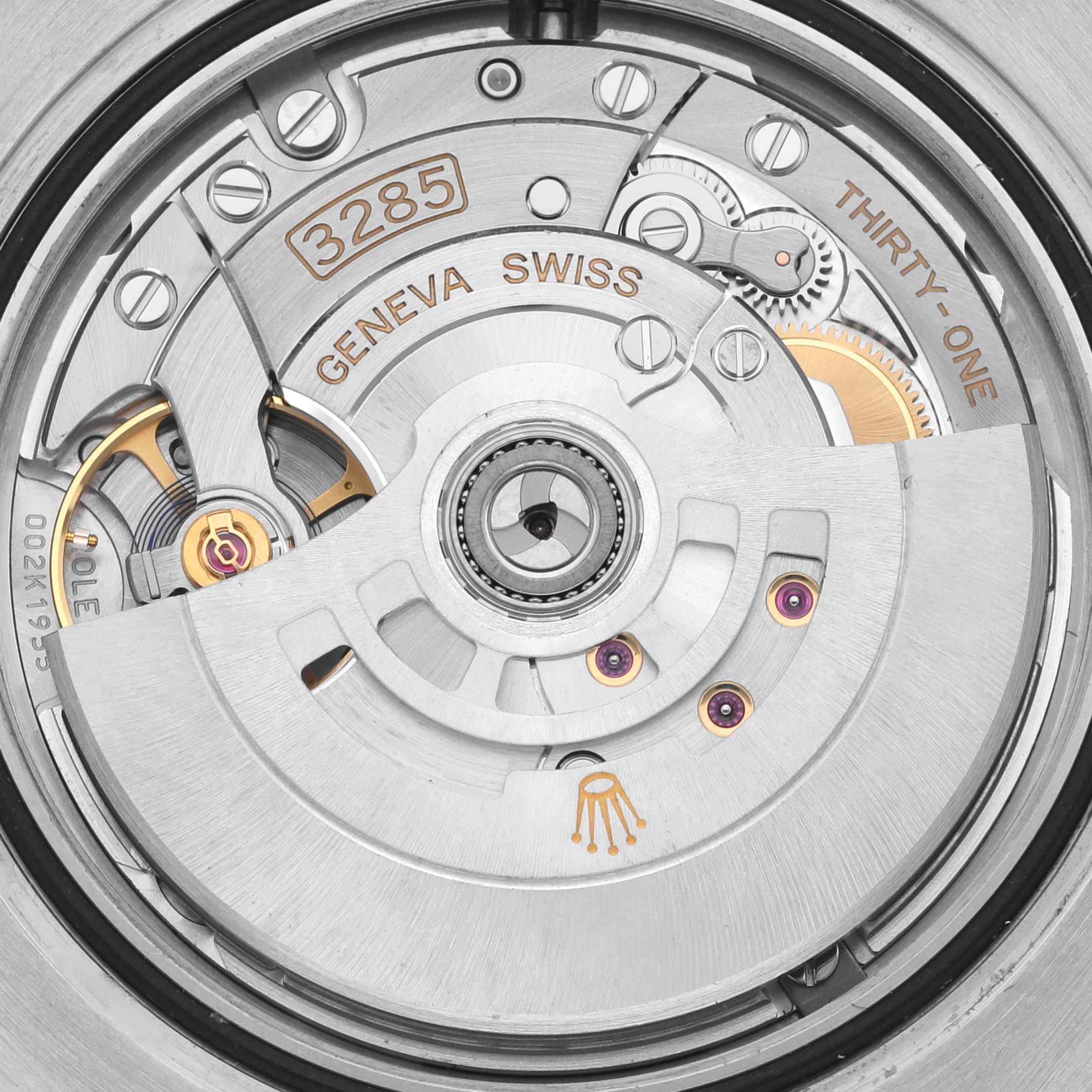 This image shows the movement of a Rolex GMT-Master 126711 Men's Steel and Gold (two tone) Black Dial 126711 Men's Steel and Gold (two tone) Black Dial, focusing on the intricate gears and rotor from a back angle.