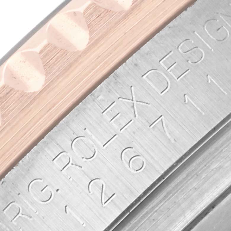 The image shows a close-up of the engraved side of a Rolex GMT-Master 126711 Men's Steel and Gold (two tone) Black Dial 126711 Men's Steel and Gold (two tone) Black Dial, featuring the case edge and bezel details.