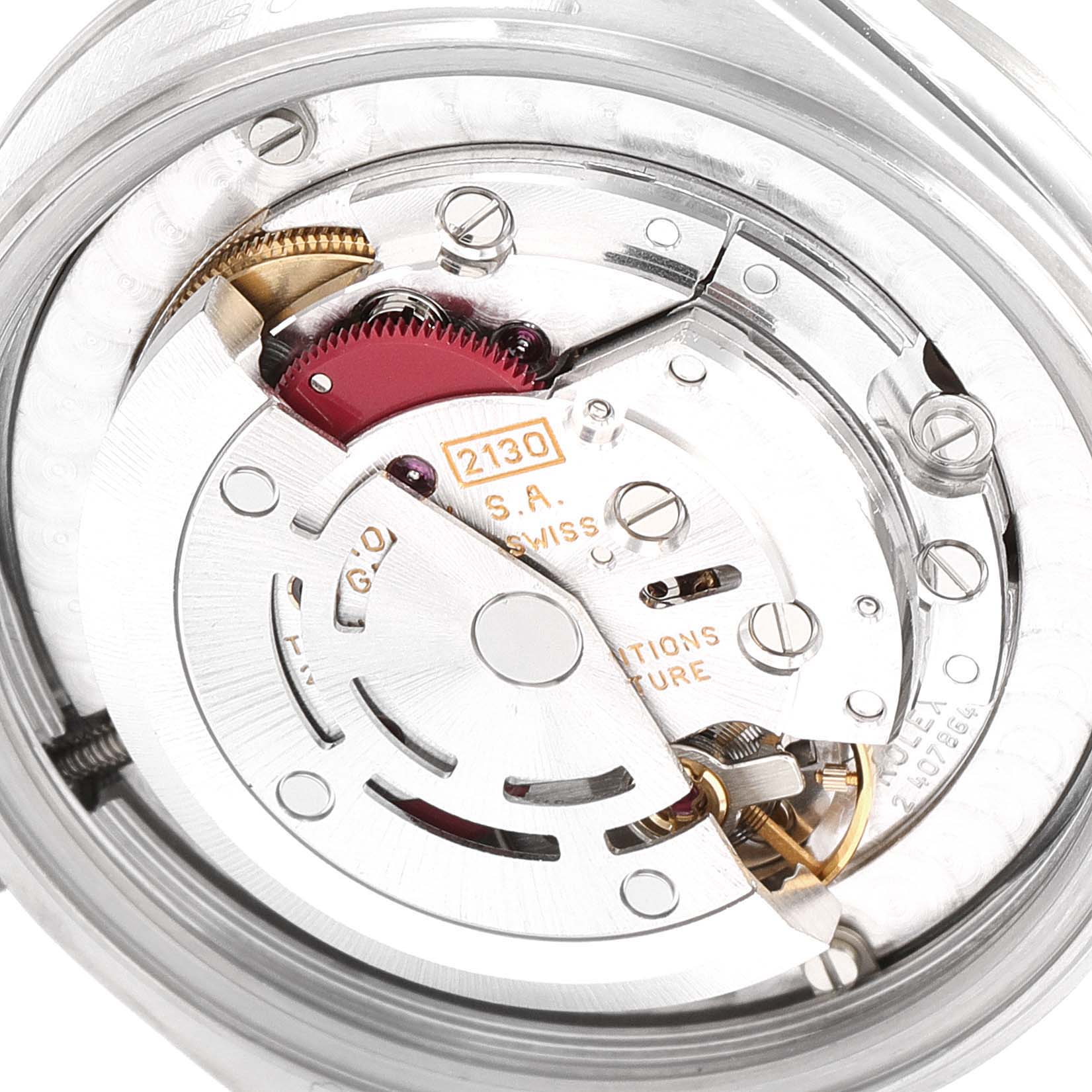 The image shows the case back view of a Rolex Mid-Size 67480 Women
s Stainless Steel Pink Dial 67480 Women
s Stainless Steel Pink Dial watch, highlighting its inner mechanical movement.