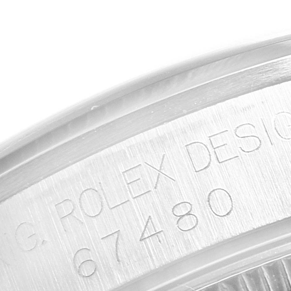 This image shows a close-up of the engraved casing with the model number "67480" on a Rolex Mid-Size 67480 Women
s Stainless Steel Pink Dial 67480 Women
s Stainless Steel Pink Dial watch.