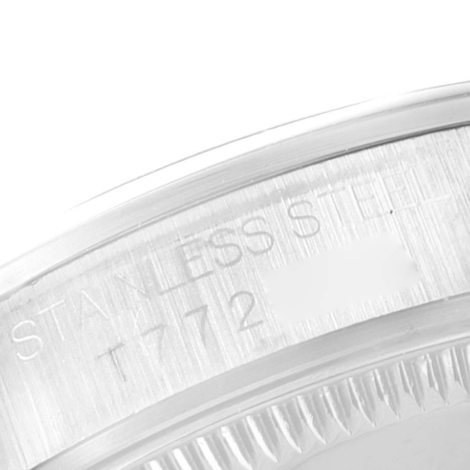 The image shows a close-up view of the serial engraving on the stainless steel case of a Rolex Mid-Size 67480 Women
s Stainless Steel Blue Dial 67480 Women
s Stainless Steel Blue Dial model watch.