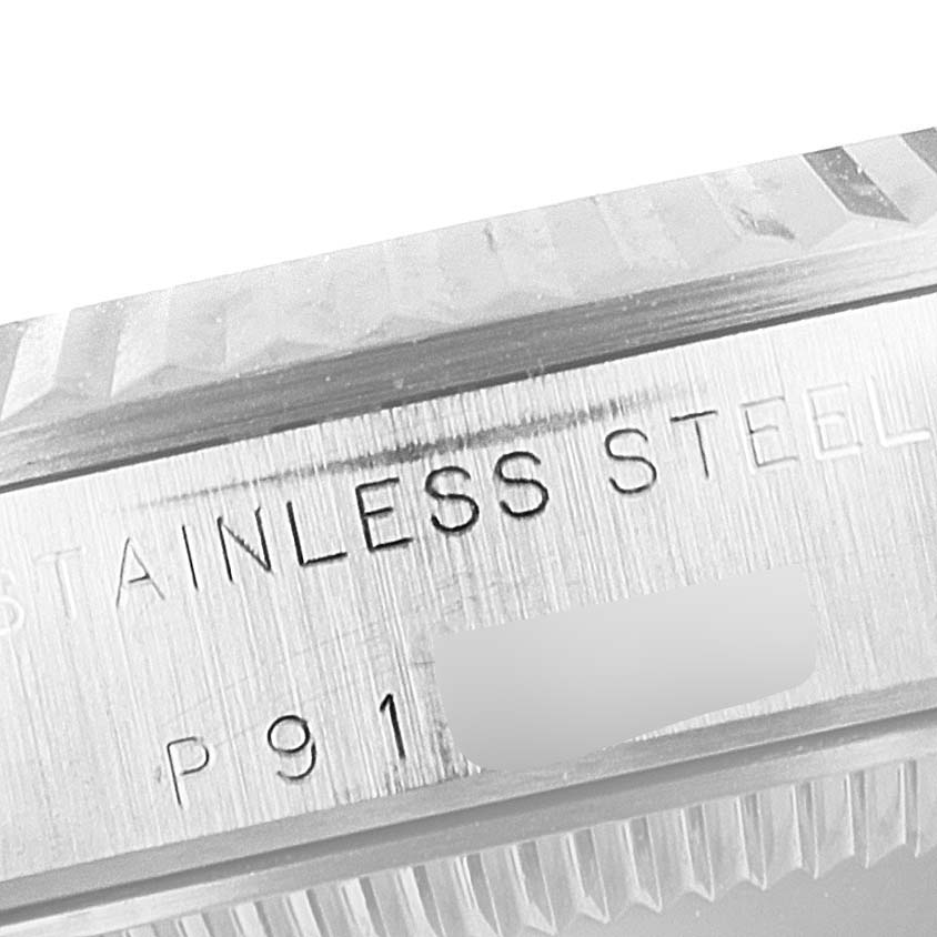 This close-up image shows the bezel and part of the case detailing "STAINLESS STEEL" on a Mid-Size Rolex watch.