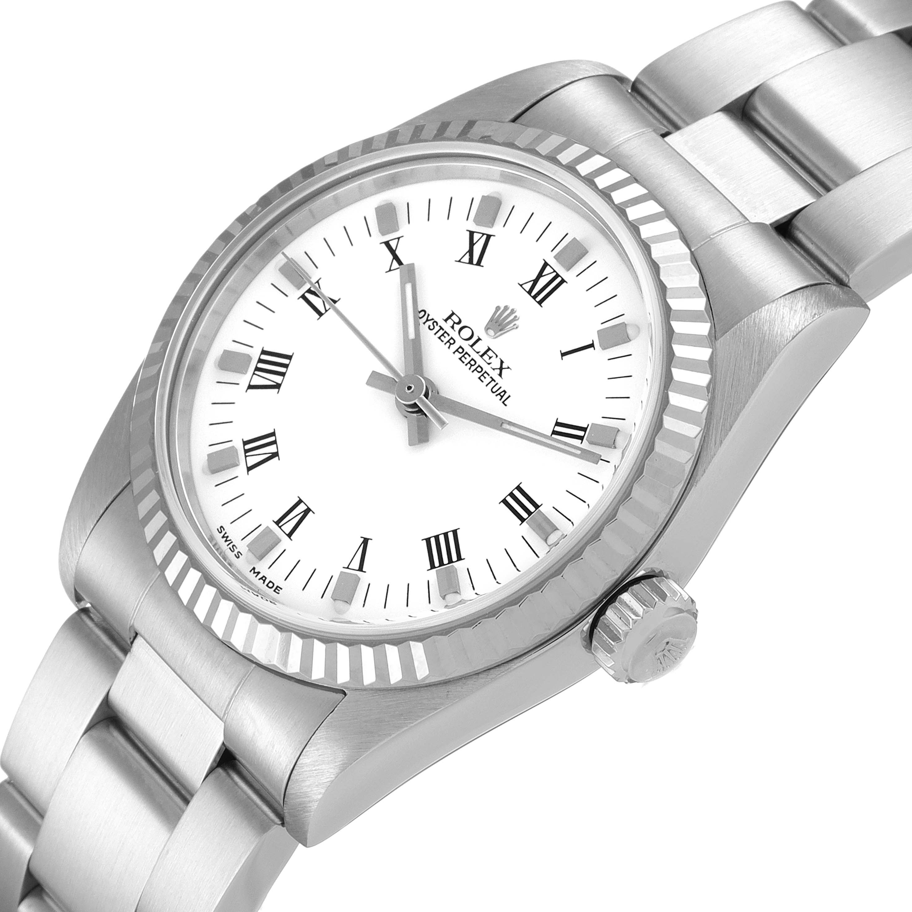 The image shows a tilted view of a Rolex Mid-Size 77014 Women
s Stainless Steel White Dial 77014 Women
s Stainless Steel White Dial model, highlighting the watch face, bezel, crown, and part of the bracelet.