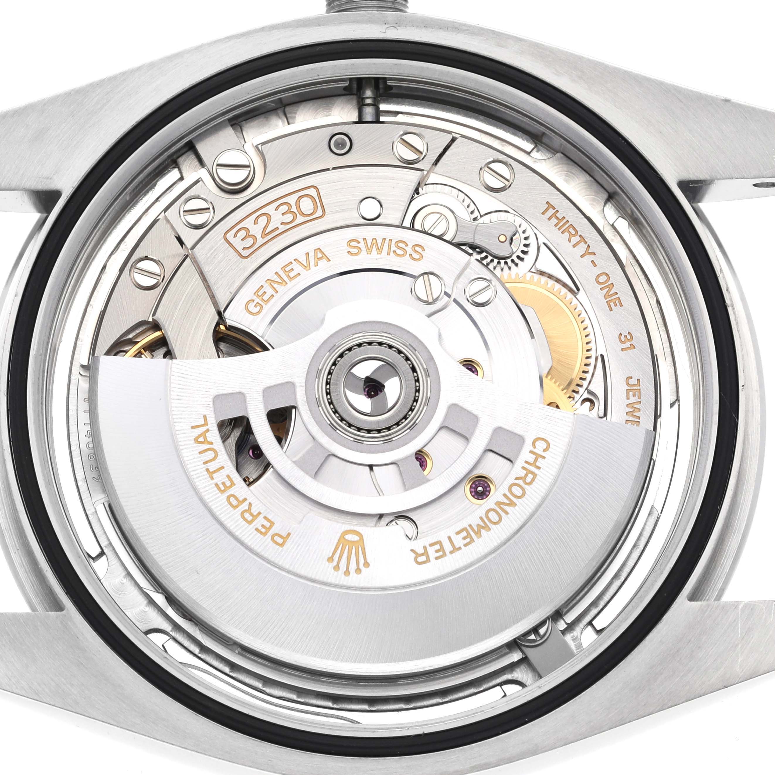 The image shows the Rolex Oyster Perpetual 124300 Men's Stainless Steel Silver Dial 124300 Men's Stainless Steel Silver Dial's movement, focusing on the rotor and internal components from a rear angle.