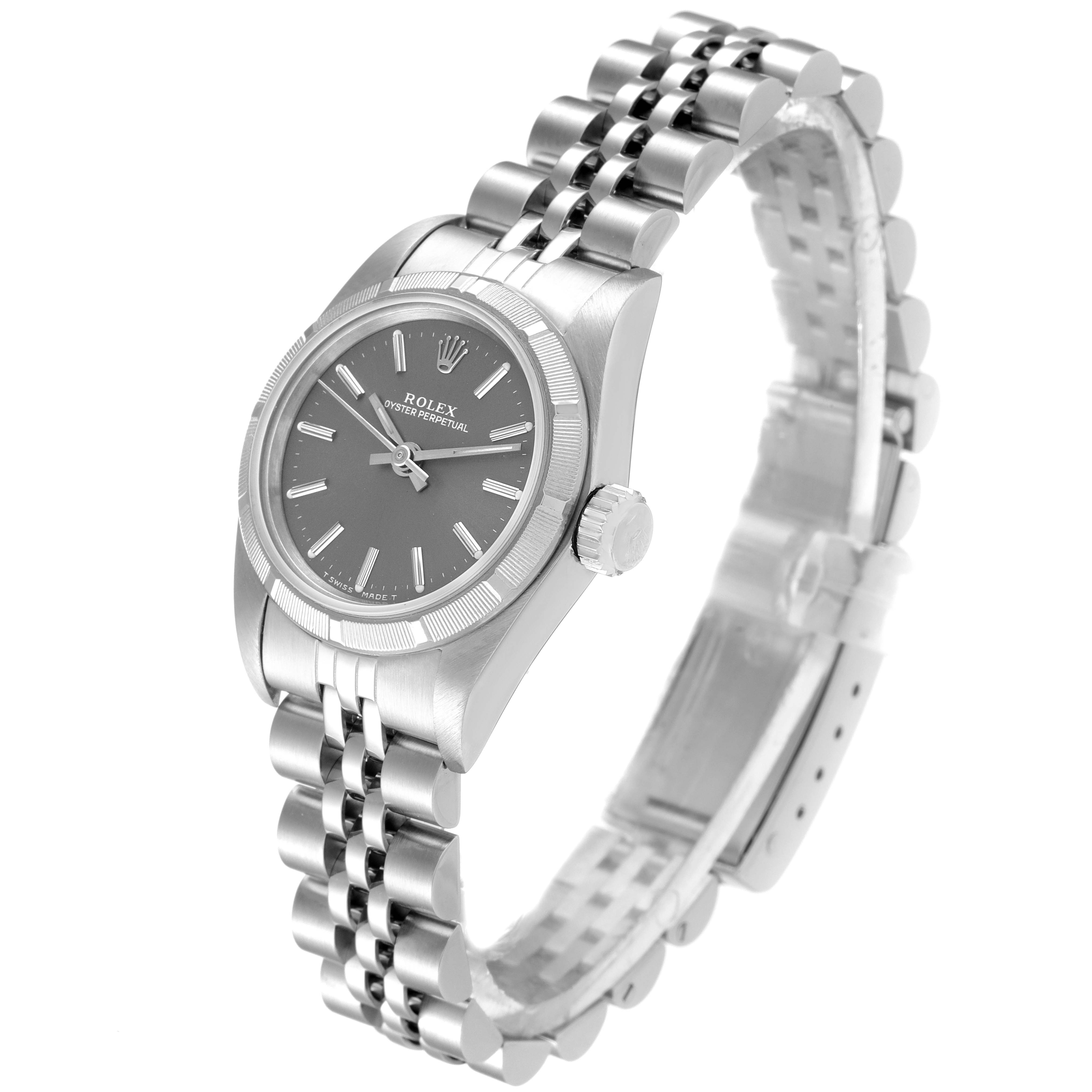 The image shows a side angle view of the Rolex Oyster Perpetual 67230 Women's Stainless Steel Grey Dial 67230 Women's Stainless Steel Grey Dial watch, displaying its dial, bezel, crown, and Jubilee bracelet.