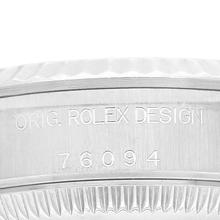 This is a close-up view of the side case of a Rolex Oyster Perpetual 76094 Women
s Stainless Steel Pink Dial 76094 Women
s Stainless Steel Pink Dial watch, showing the engraved design text and model number.