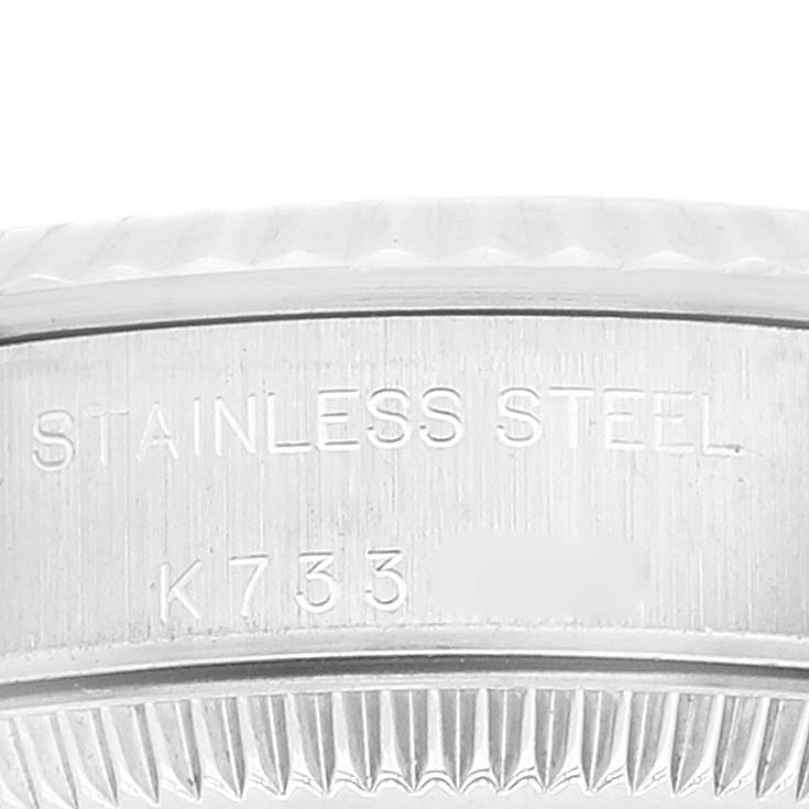 This image shows a close-up of the side engraving on the case of a Rolex Oyster Perpetual 76094 Women
s Stainless Steel Pink Dial 76094 Women
s Stainless Steel Pink Dial watch, indicating "STAINLESS STEEL" and partial serial number "K733."