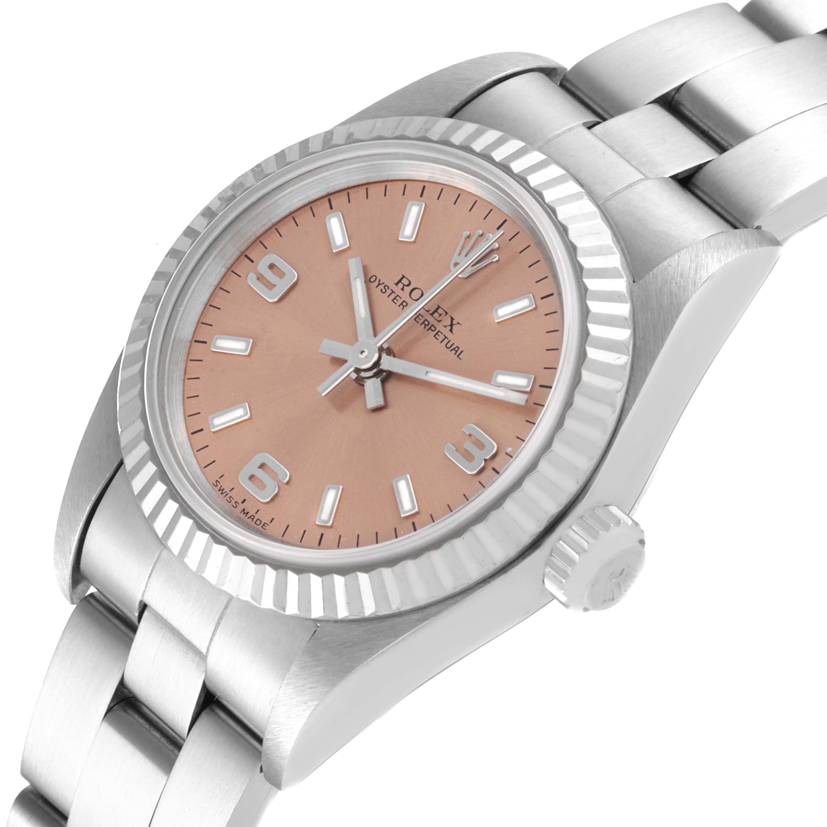 The image shows a close-up angle of the Rolex Oyster Perpetual 76094 Women
s Stainless Steel Pink Dial 76094 Women
s Stainless Steel Pink Dial watch, highlighting the dial, bezel, crown, and part of the bracelet.