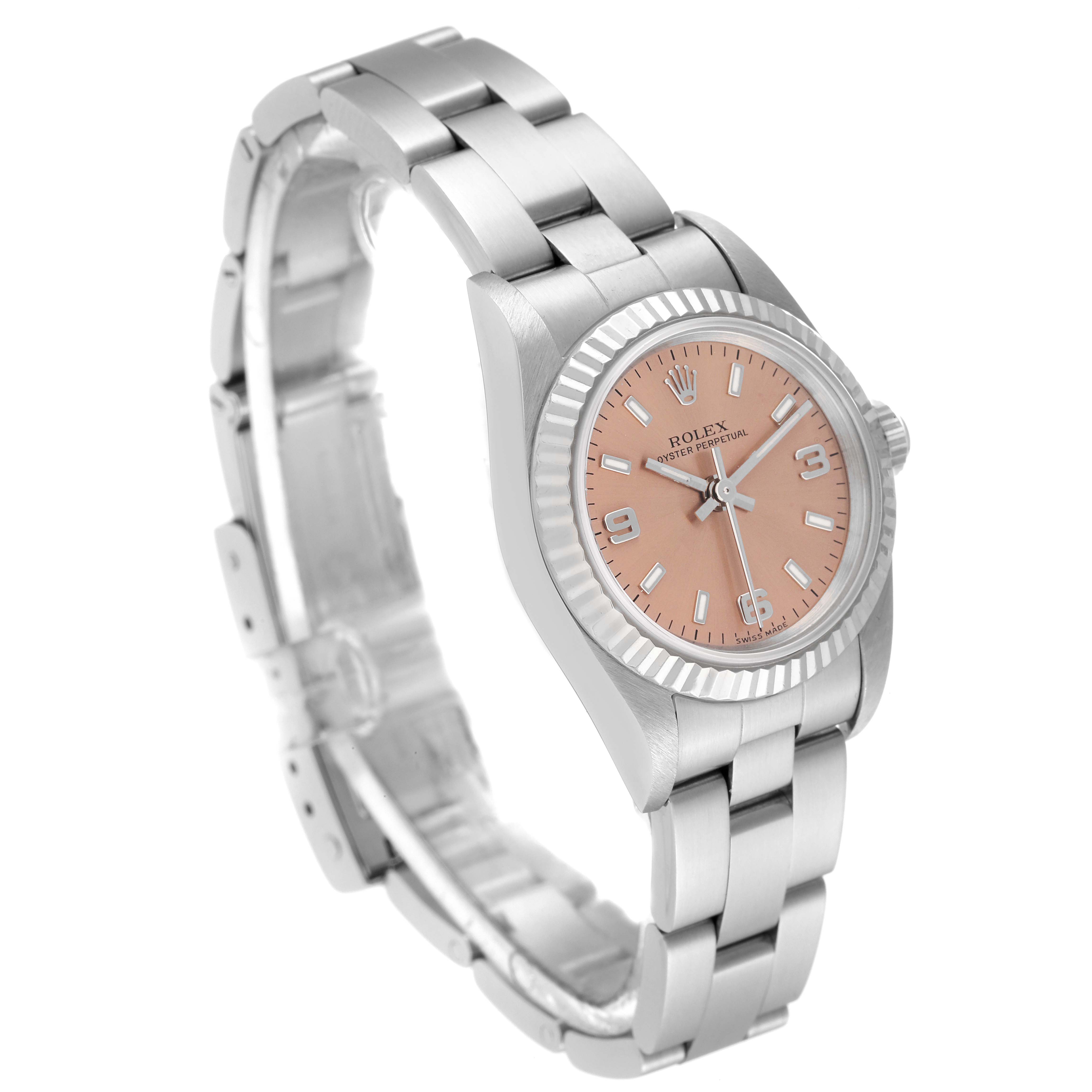 The Rolex Oyster Perpetual 76094 Women
s Stainless Steel Pink Dial 76094 Women
s Stainless Steel Pink Dial watch is shown at an angle displaying its bracelet, case, dial, and crown.