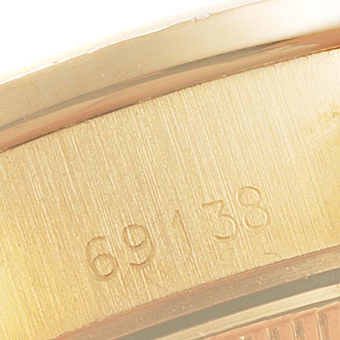The image shows a close-up of the casing and model number "69138" etched on a Rolex President 69138 Women's Yellow Gold Champagne Dial 69138 Women's Yellow Gold Champagne Dial watch.