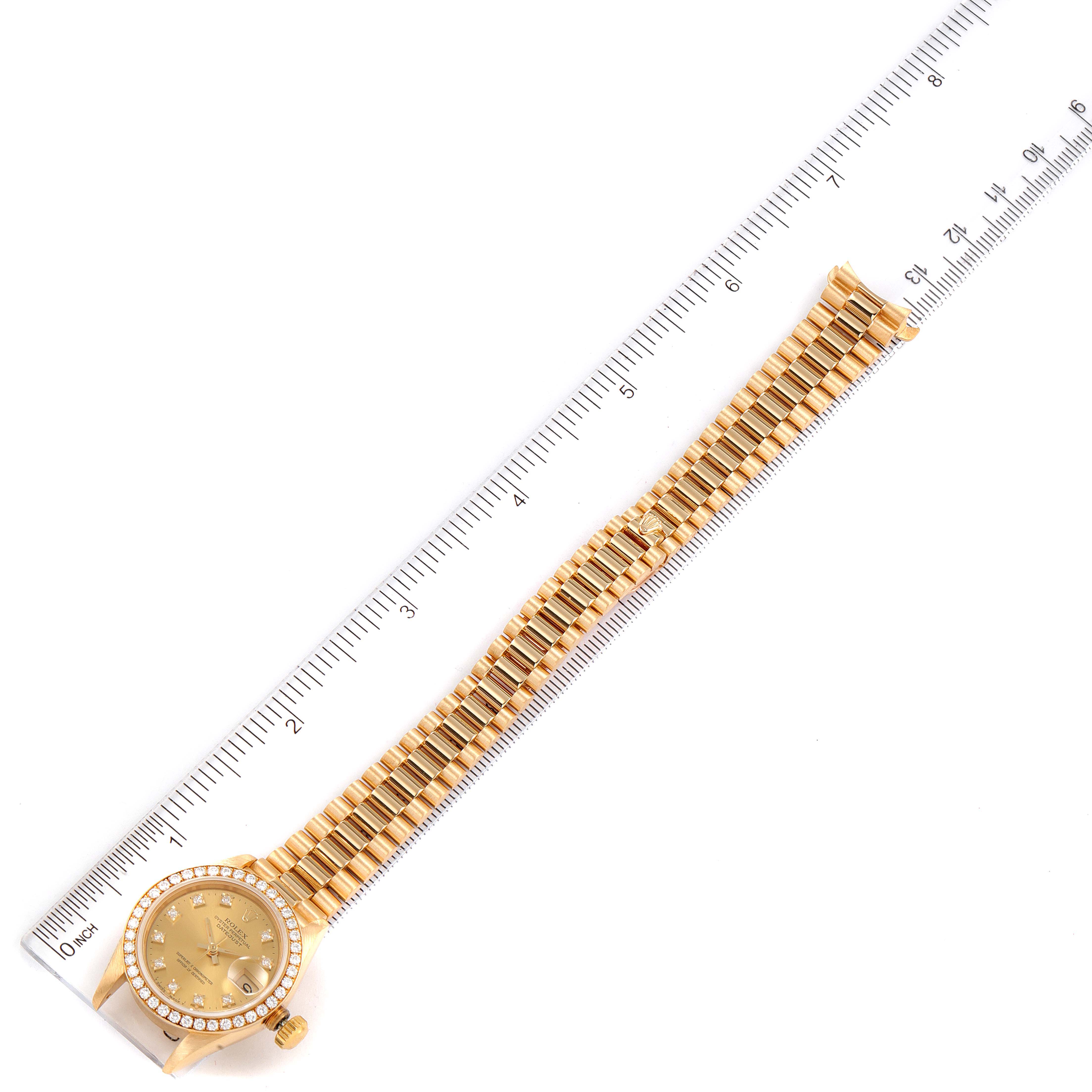The image shows a Rolex President 69138 Women's Yellow Gold Champagne Dial 69138 Women's Yellow Gold Champagne Dial model watch laid flat, including the dial, bezel, and full bracelet, next to a ruler for size reference.