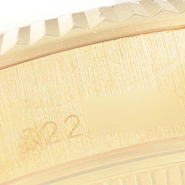 This close-up image shows the engraved inner rim and part of the fluted bezel of a Rolex President 69178 Women
s Yellow Gold Champagne Dial 69178 Women
s Yellow Gold Champagne Dial model watch.