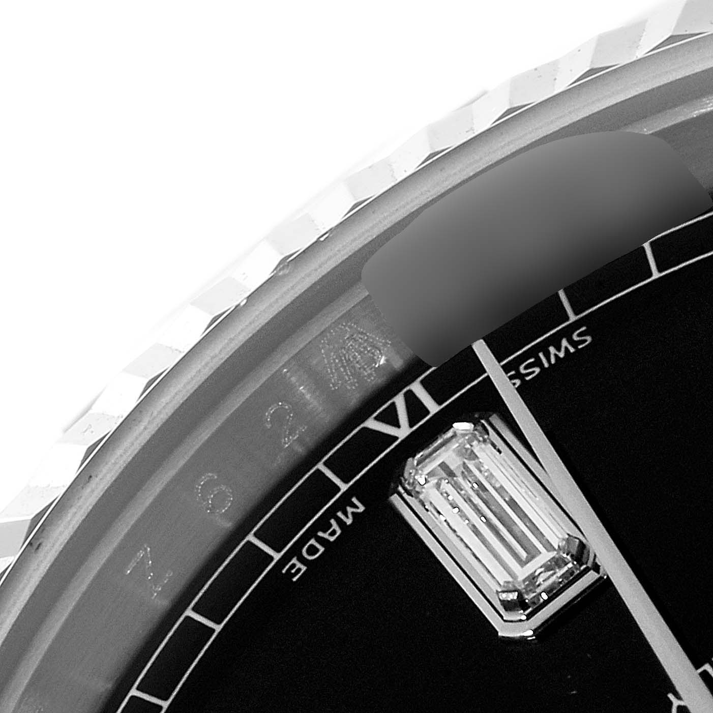 This close-up shows the upper part of the Rolex President 118339 Men's White Gold Black Dial 118339 Men's White Gold Black Dial watch model's dial including the bezel, markers, and the "Swiss Made" text.