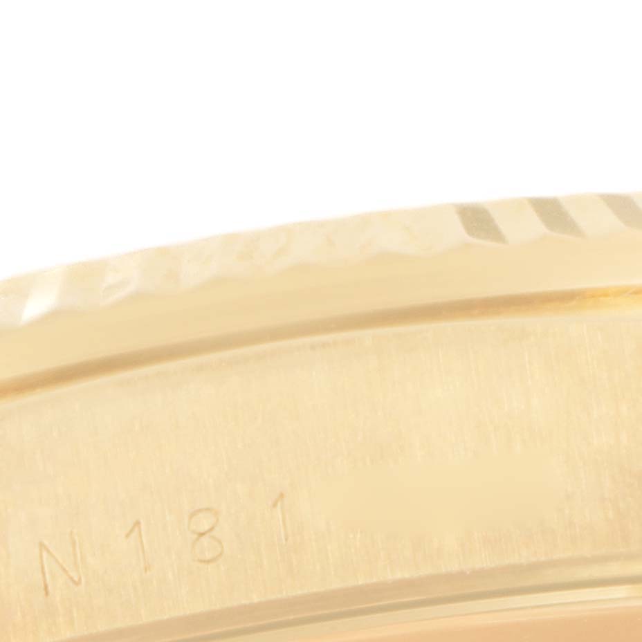 This is a close-up image of the bezel and part of the case of a Rolex President 18238 Men's Yellow Gold Champagne Dial 18238 Men's Yellow Gold Champagne Dial model watch, showing a small portion of its engravings.