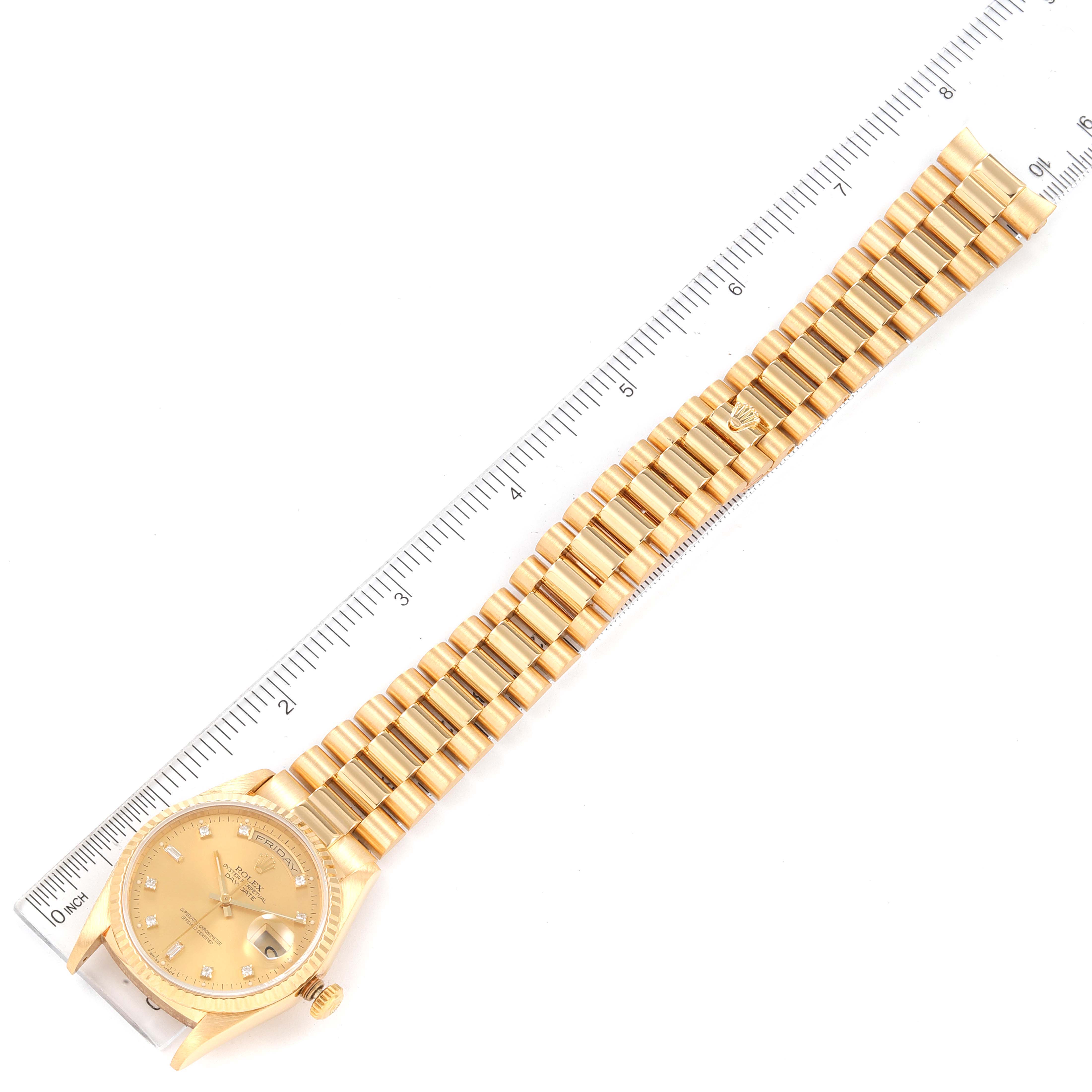 The image shows a top-down view of a Rolex President 18238 Men's Yellow Gold Champagne Dial 18238 Men's Yellow Gold Champagne Dial model watch, featuring the watch face, band, and a ruler for scale.
