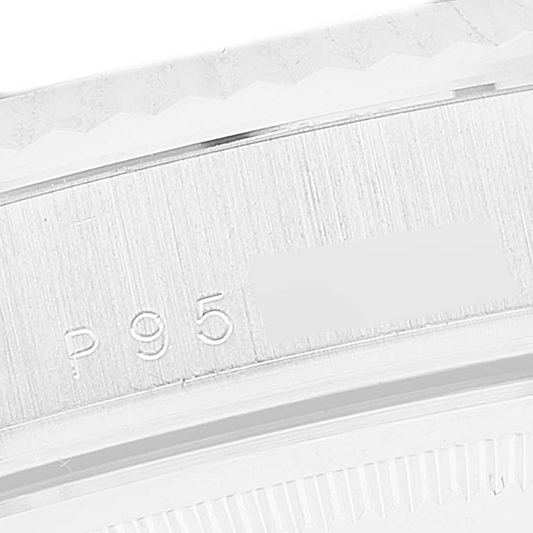 The image shows a close-up of a Rolex President 118239 Men's White Gold Blue Dial 118239 Men's White Gold Blue Dial model's case with visible serial number and part of the bezel.
