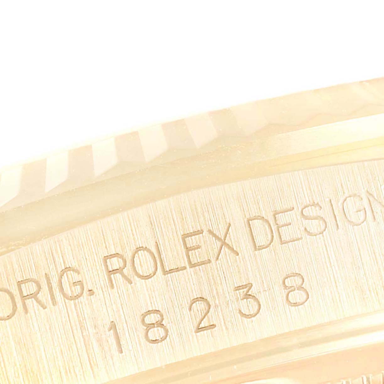 This image shows a close-up of the engraved model number on the side of the bezel of a Rolex President 18238 Men
s Yellow Gold Champagne Dial 18238 Men
s Yellow Gold Champagne Dial watch.