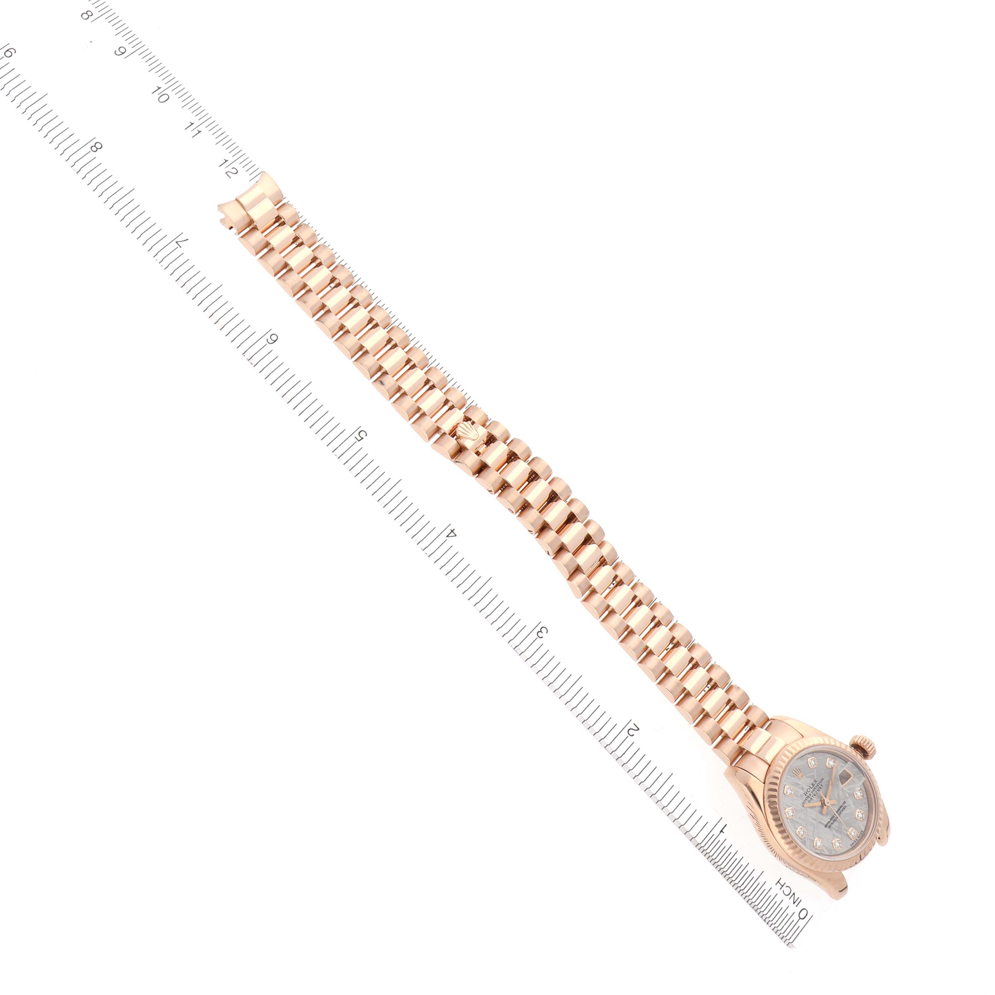 The image shows a Rolex President 179175 Women's Rose Gold Silver Dial 179175 Women's Rose Gold Silver Dial watch at an overhead angle, displaying its face and full bracelet alongside a ruler for scale.