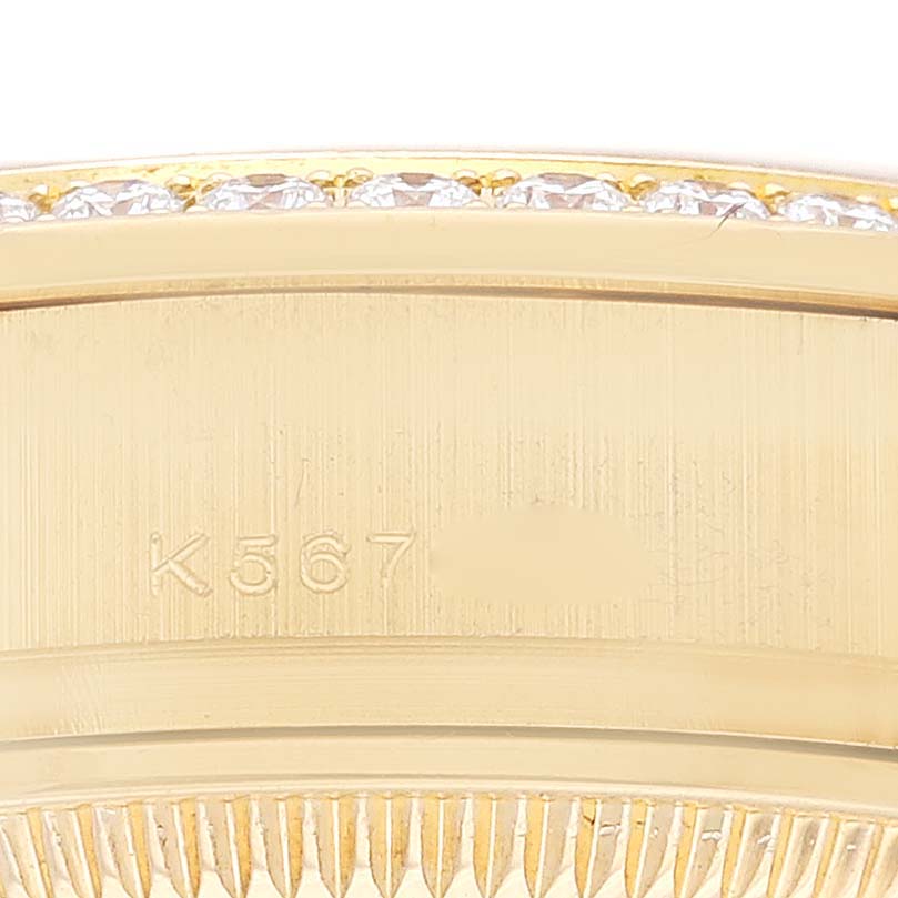 This image shows a close-up of the side of a Rolex President 179138G Women's Yellow Gold Champagne Dial 179138G Women's Yellow Gold Champagne Dial watch, highlighting the serial number and diamond-encrusted bezel.