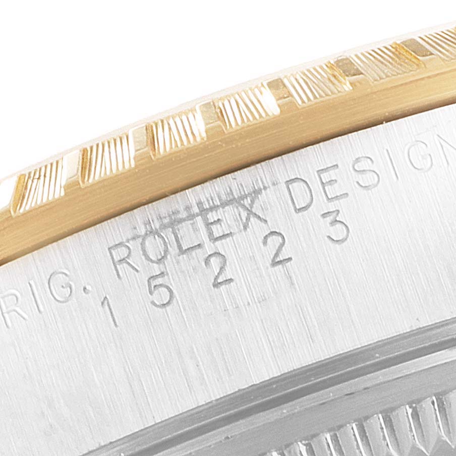 This close-up image shows the engraved case and fluted bezel of a Rolex Date 15223 Men's Steel and Gold (two tone) Black Dial 15223 Men's Steel and Gold (two tone) Black Dial model watch.