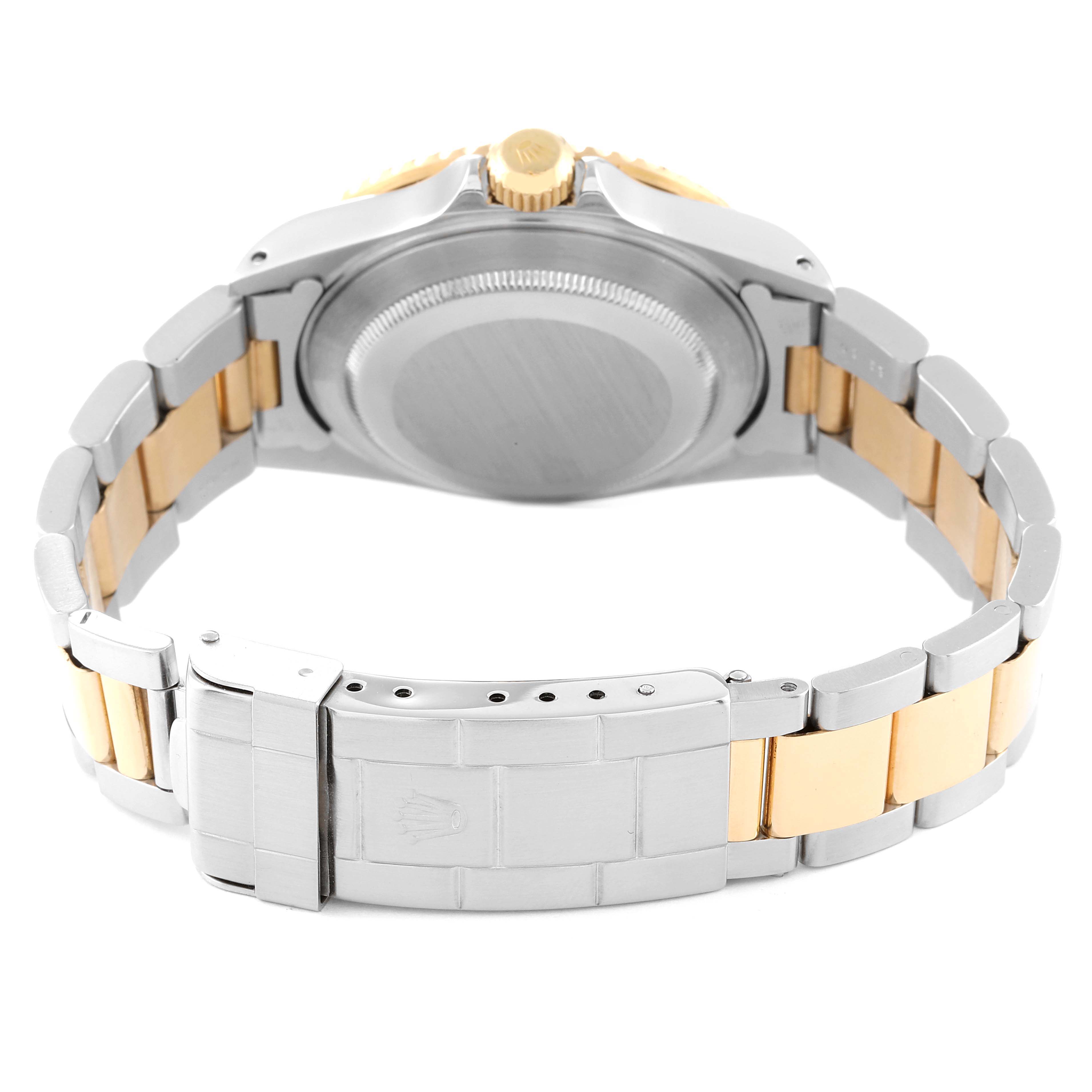 This image shows the back side of a Rolex Submariner 16613 Men's Steel and Gold (two tone) Blue Dial 16613 Men's Steel and Gold (two tone) Blue Dial watch, focusing on the bracelet, clasp, and case back.