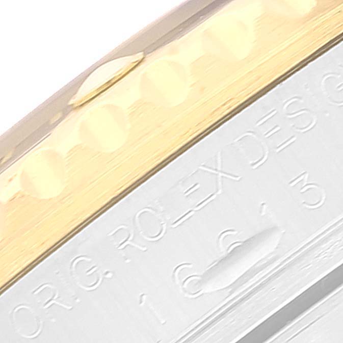 The image shows a close-up angle of the bezel and part of the casing of a Rolex Submariner 16613 Men's Steel and Gold (two tone) Blue Dial 16613 Men's Steel and Gold (two tone) Blue Dial watch.