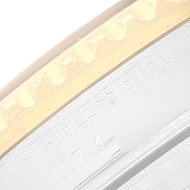 The image shows a close-up view of the stainless steel case and bezel edge of a Rolex Submariner 16613 Men's Steel and Gold (two tone) Blue Dial 16613 Men's Steel and Gold (two tone) Blue Dial watch.