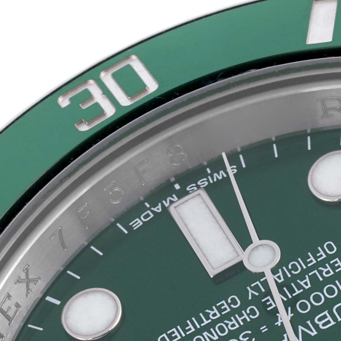 The image shows the bezel, dial, and part of the minute hand of a Rolex Submariner 116610LV Men's Stainless Steel Green Dial 116610LV Men's Stainless Steel Green Dial at an oblique angle.