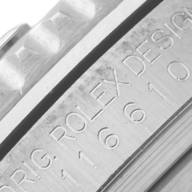The image shows a close-up of the engraved side of a Rolex Submariner 116610LV Men
s Stainless Steel Green Dial 116610LV Men
s Stainless Steel Green Dial case, including part of the bezel.
