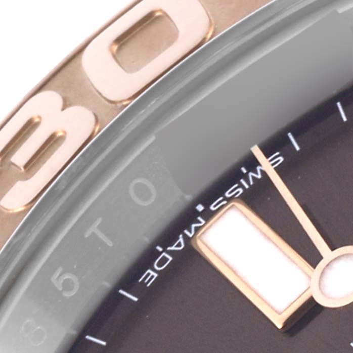 The image shows a close-up of the Rolex Yacht-Master 116621 Men's Steel and Gold (two tone) Brown Dial 116621 Men's Steel and Gold (two tone) Brown Dial's bezel and dial, focusing on the numbers and markers.