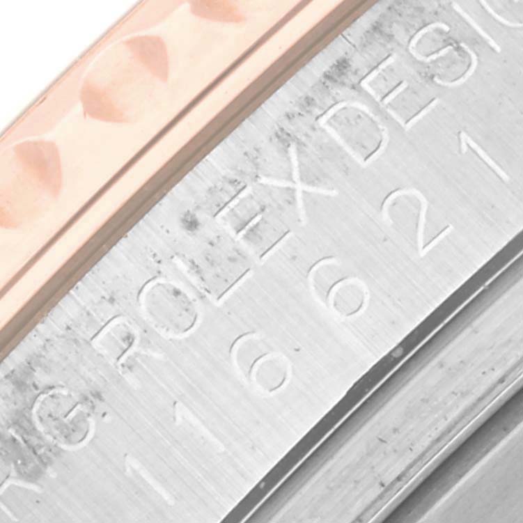 The image shows a close-up of the engraved side of the Rolex Yacht-Master 116621 Men's Steel and Gold (two tone) Brown Dial 116621 Men's Steel and Gold (two tone) Brown Dial's bezel and casing.