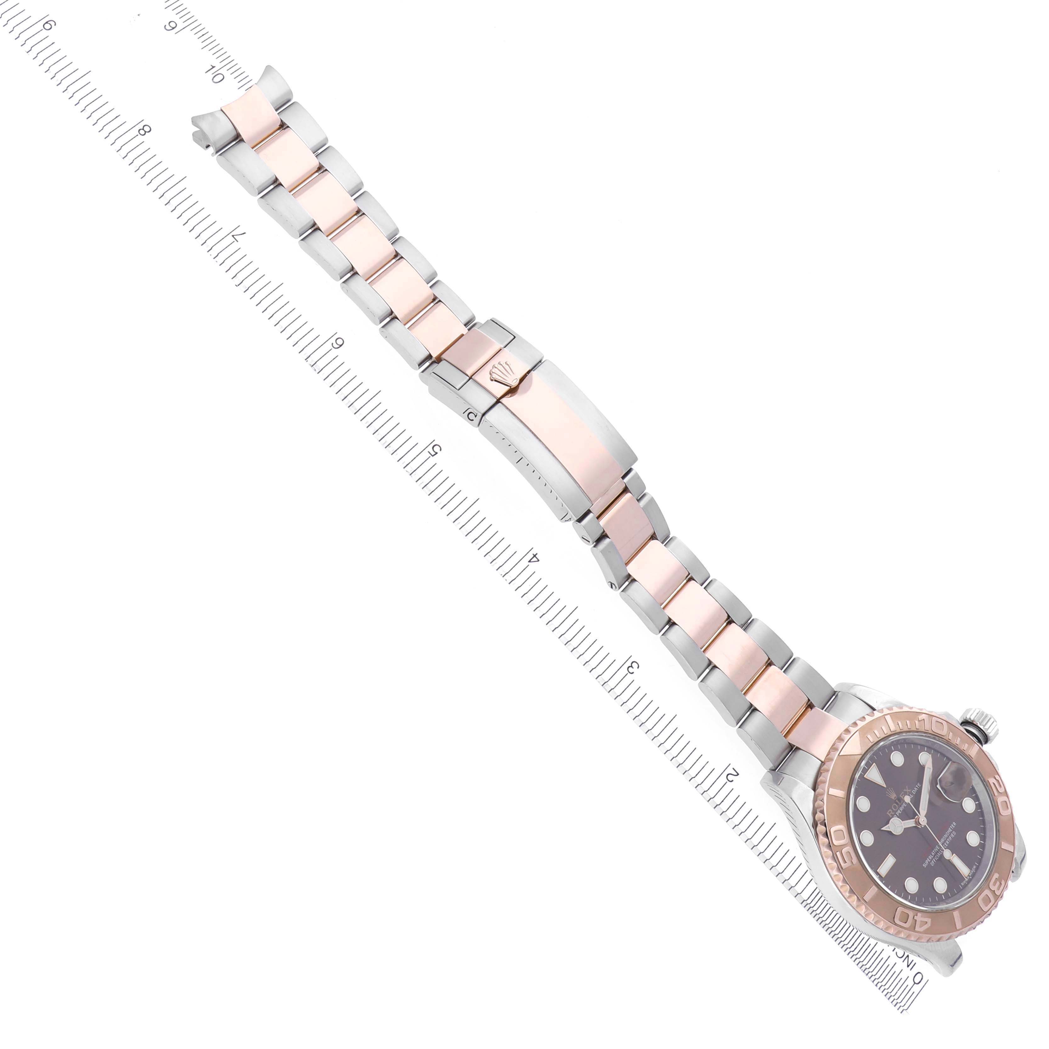The Rolex Yacht-Master 116621 Men's Steel and Gold (two tone) Brown Dial 116621 Men's Steel and Gold (two tone) Brown Dial watch is shown diagonally with a focus on its bracelet and clasp.