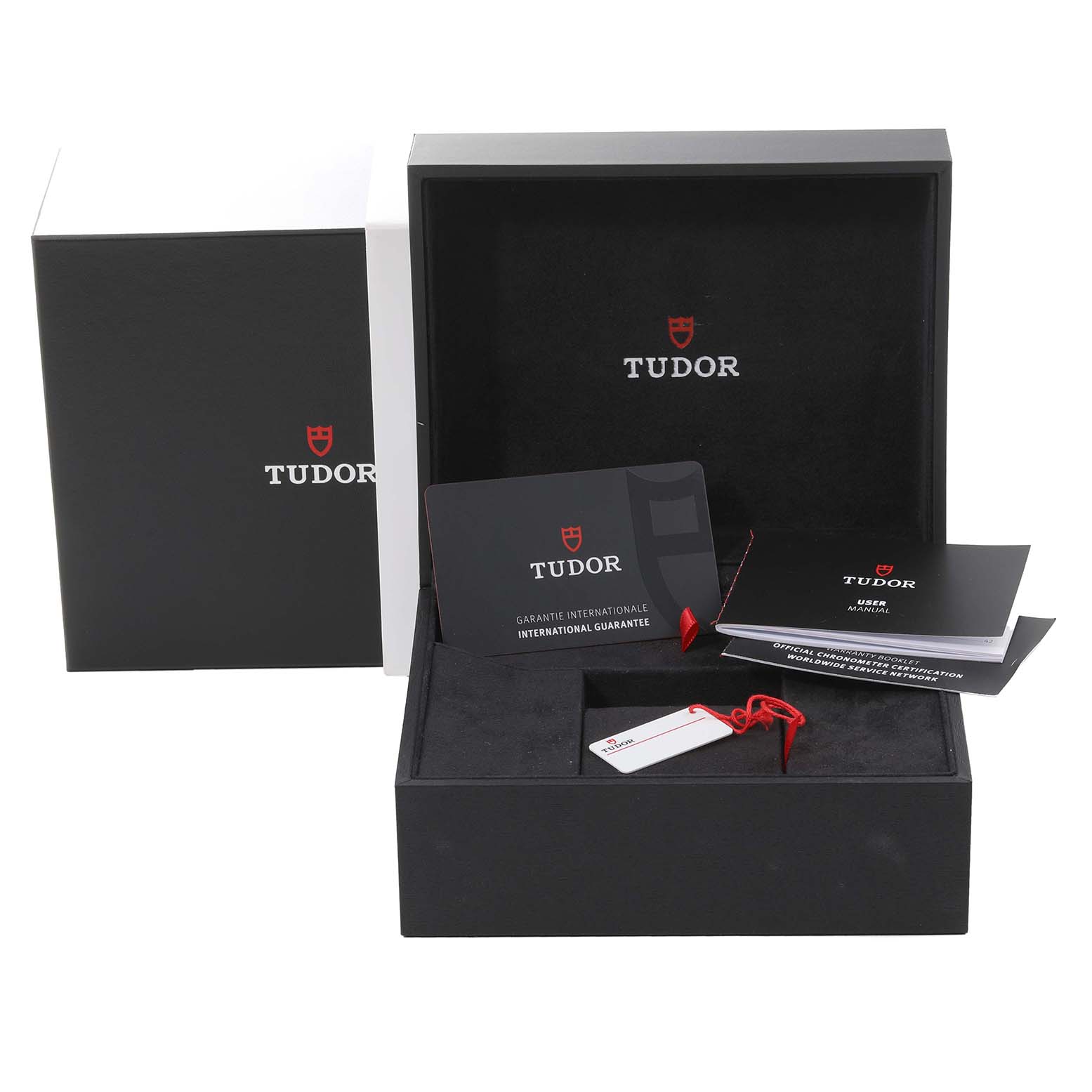 The image shows the packaging and accessories for the Tudor Heritage Black Bay 79363N Men
s Steel and Gold (two tone) Black Dial 79363N Men
s Steel and Gold (two tone) Black Dial watch, including the box, guarantee card, and user manual.