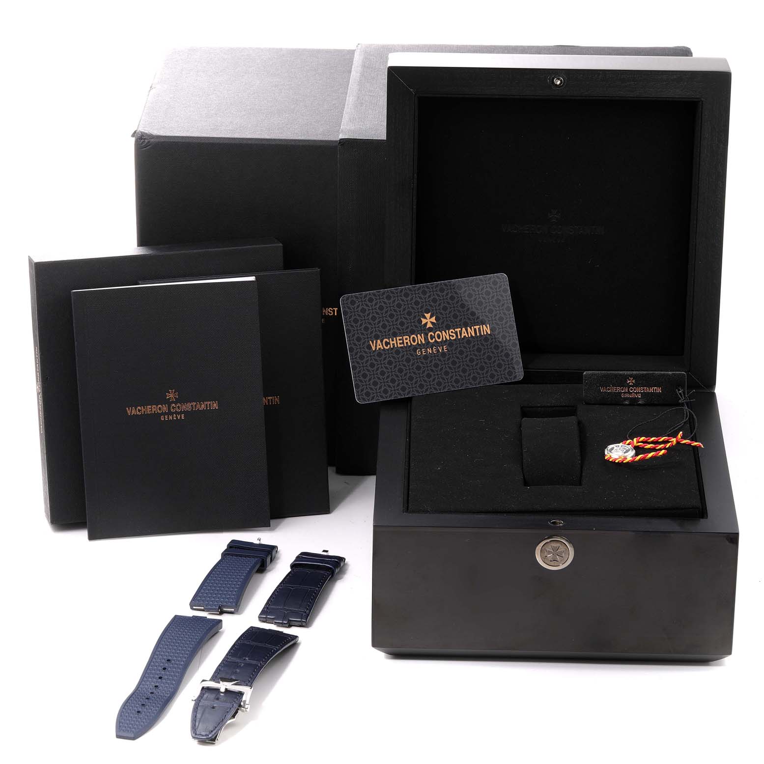 The image shows the Vacheron Constantin Overseas 7900V/110A-B334 Men's Stainless Steel Blue Dial 7900V/110A-B334 Men's Stainless Steel Blue Dial watch box, extra straps, manuals, and authenticity card at a slightly elevated angle.