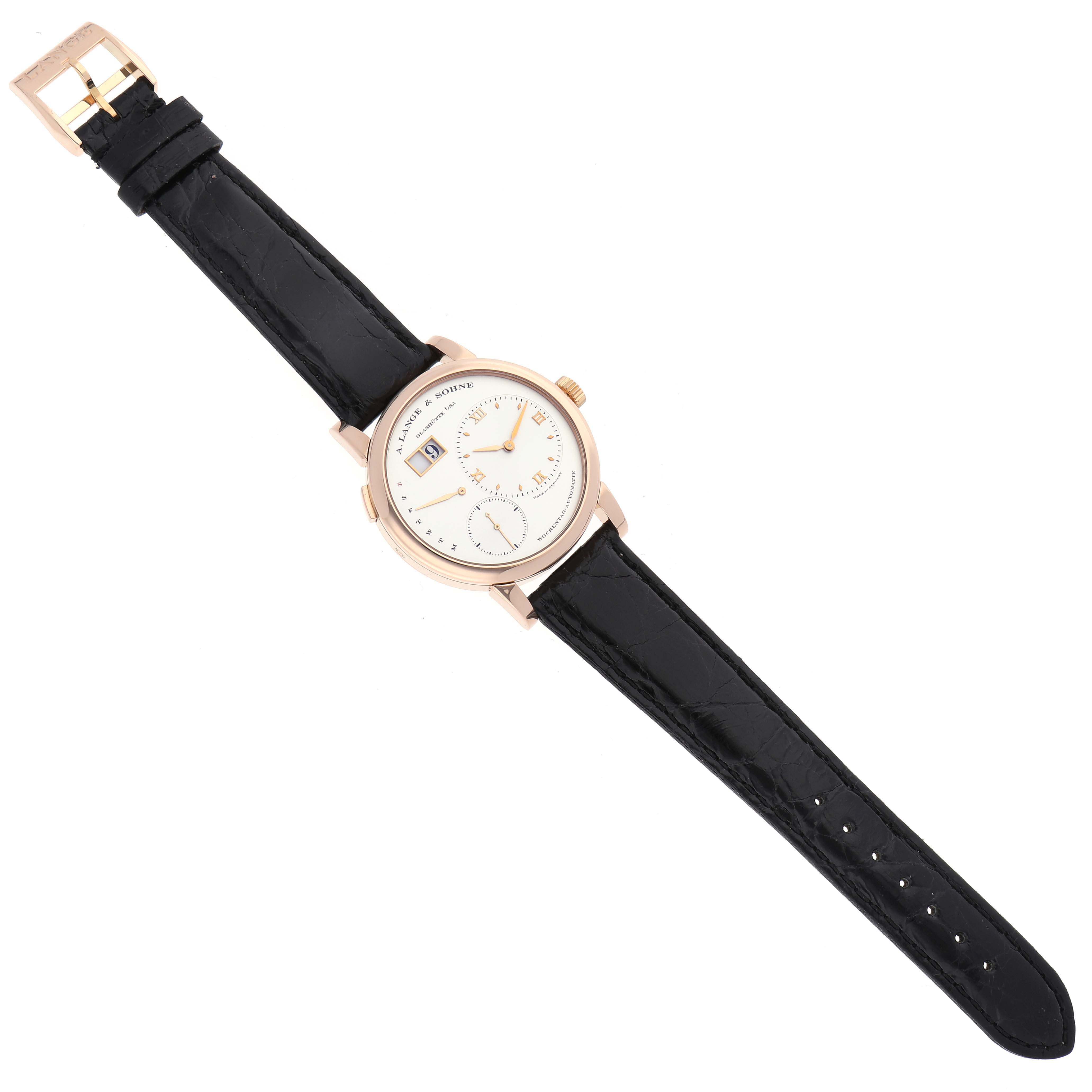 The A. Lange 
Sohne Lange 1 320.032 Men
s Rose Gold Silver Dial watch is shown from a top-down angle, displaying the entire face and black leather strap.