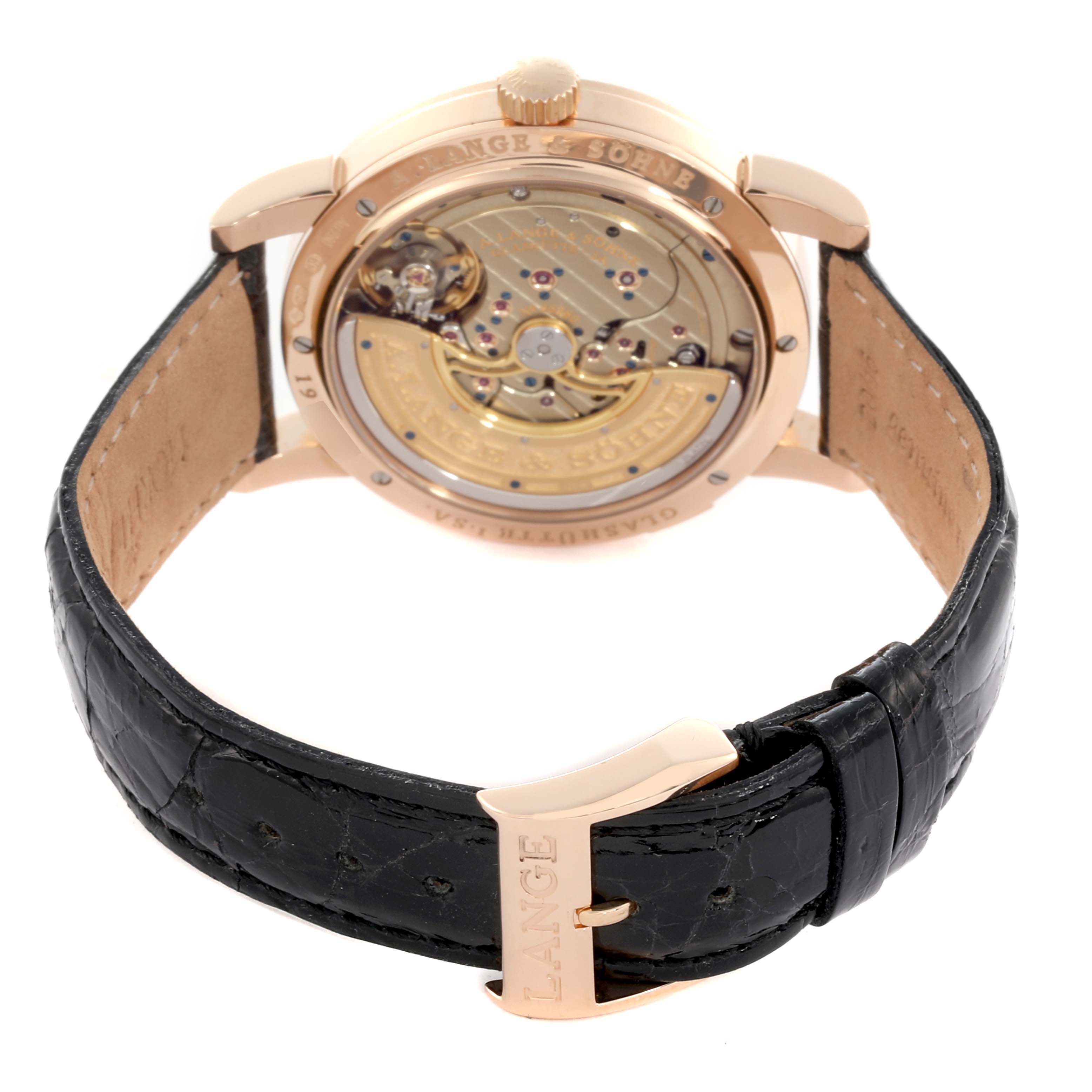 The image shows the back view of an A. Lange 
Sohne Lange 1 320.032 Men
s Rose Gold Silver Dial watch, highlighting its movement and leather strap.