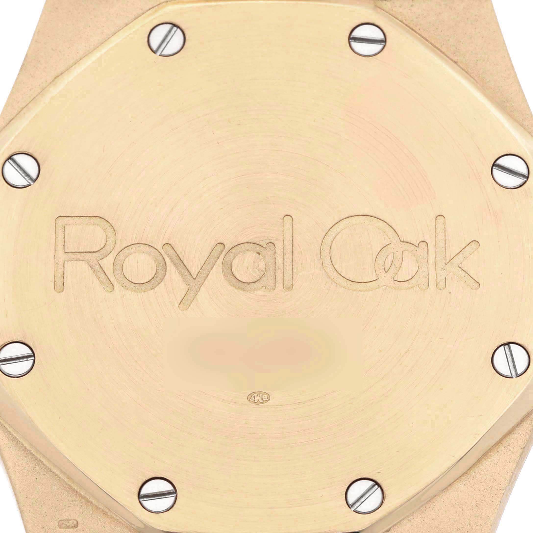 The image shows the case back of an Audemars Piguet Royal Oak 5402BA-001 Men's Yellow Gold Grey Dial watch, prominently displaying its name with screws visible.