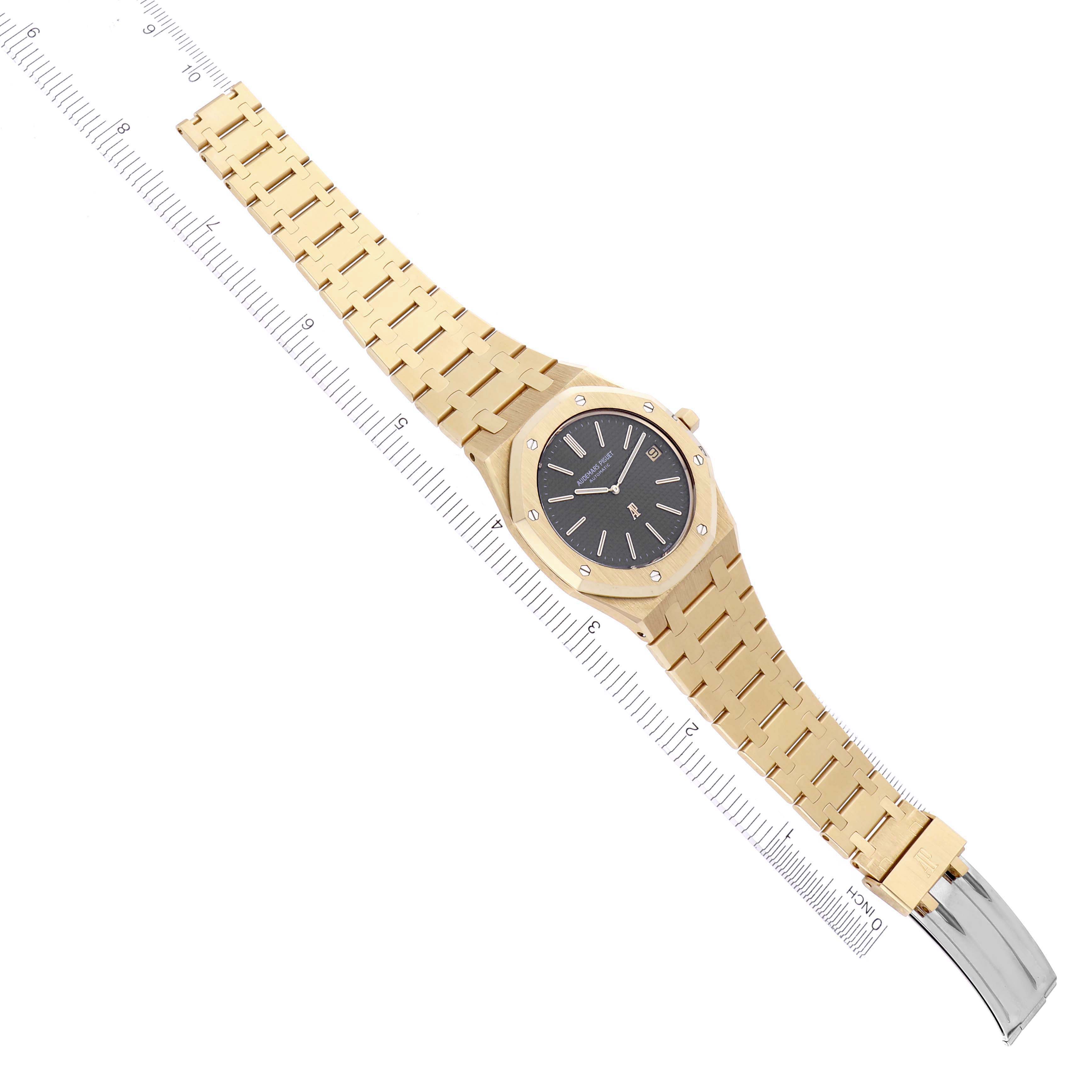 The image shows a top-down angle of an Audemars Piguet Royal Oak 5402BA-001 Men's Yellow Gold Grey Dial 5402BA-001 Men's Yellow Gold Grey Dial watch with its entire gold bracelet visible.