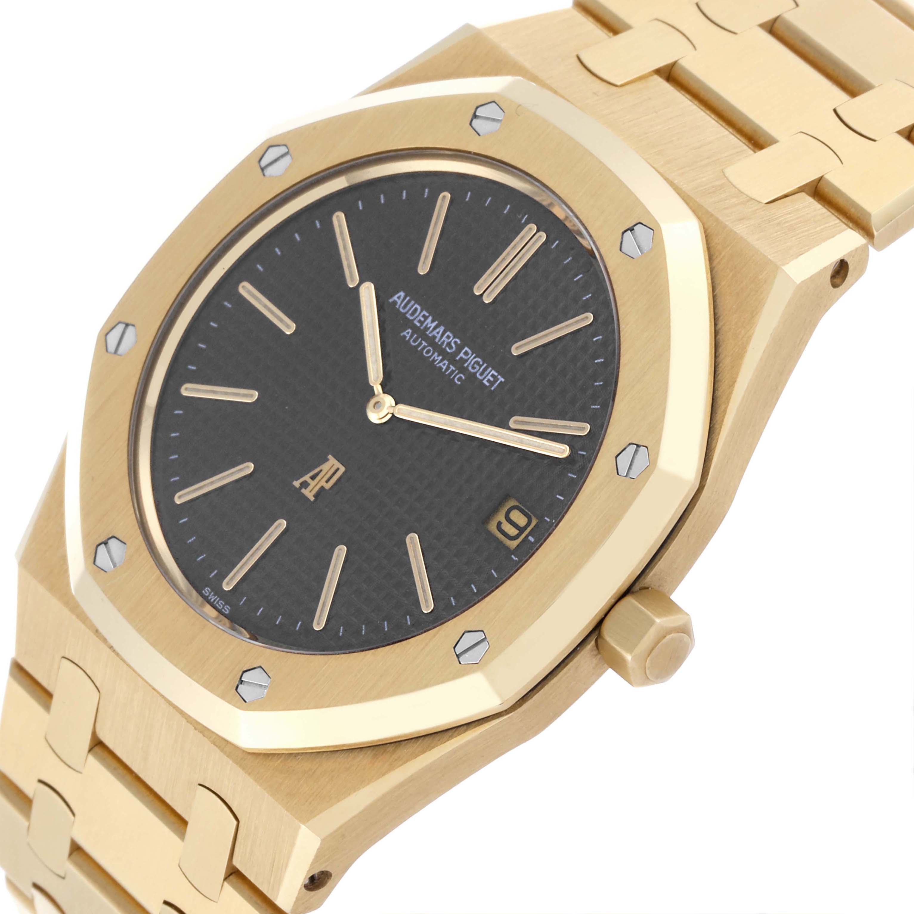 The image shows a Royal Oak by Audemars Piguet from an oblique top angle, displaying its gold case, bracelet, and black dial.