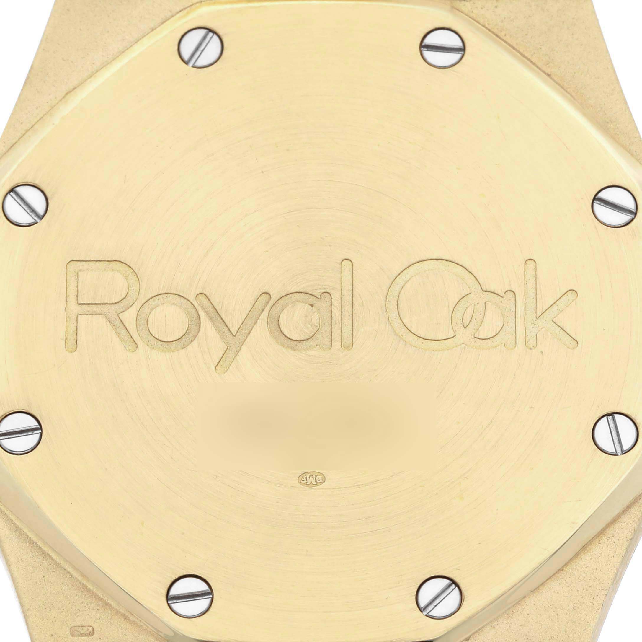 The image shows the back of an Audemars Piguet Royal Oak 5402BA-001 Men's Yellow Gold Grey Dial 5402BA-001 Men's Yellow Gold Grey Dial watch case, highlighting its screws and engraved branding.