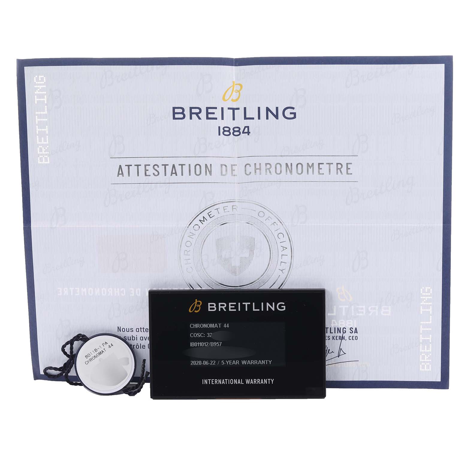 This image shows Breitling Chronomat IB0110 Men's Steel and Gold (two tone) Black Dial IB0110 Men's Steel and Gold (two tone) Black Dial watch accessories, including warranty card, tag, and certification document.