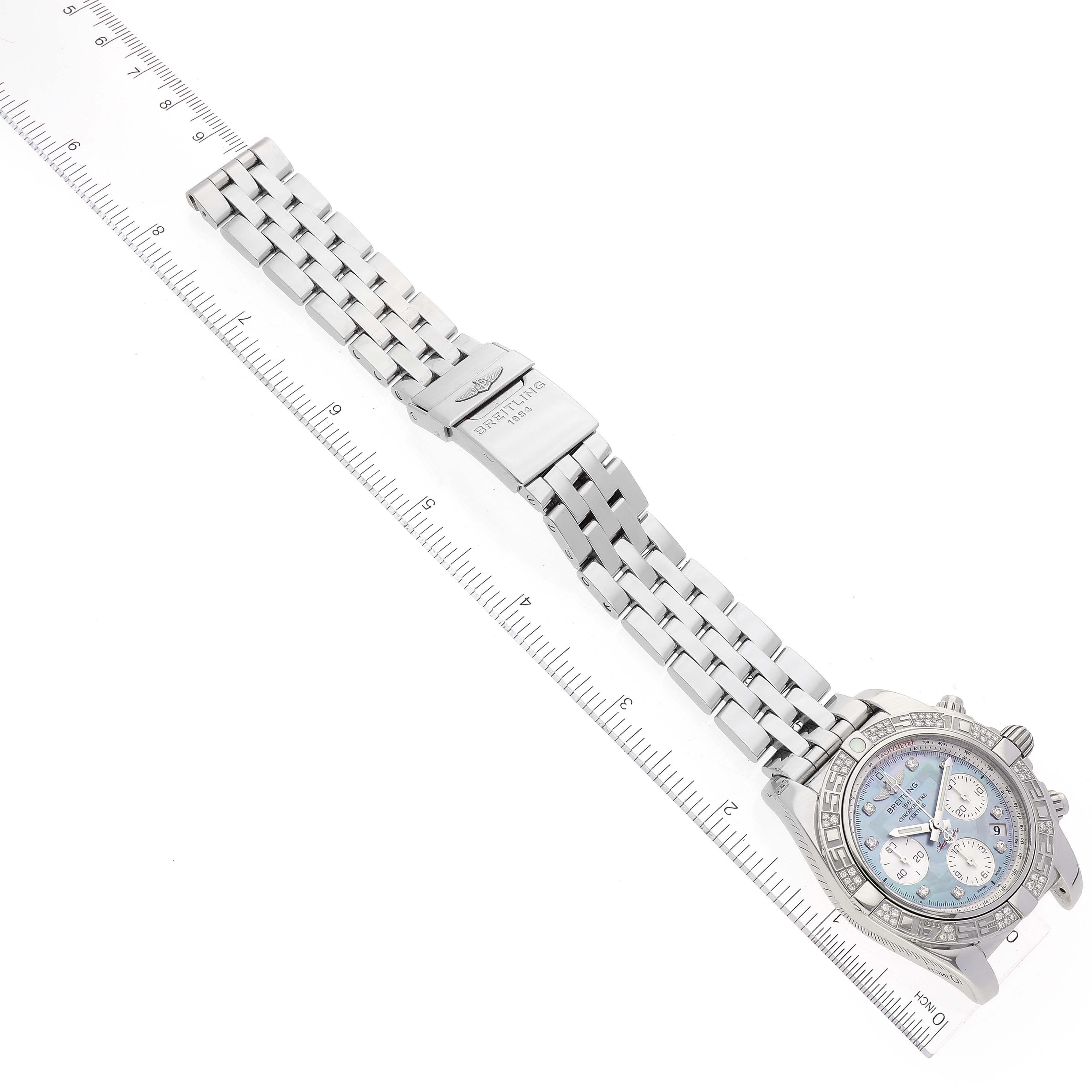 The image shows a Breitling Chronomat AB0140 Men's Stainless Steel Mother of Pearl Dial AB0140 Men's Stainless Steel Mother of Pearl Dial watch laid flat, displaying the face, bezel, and metal bracelet along a ruler.