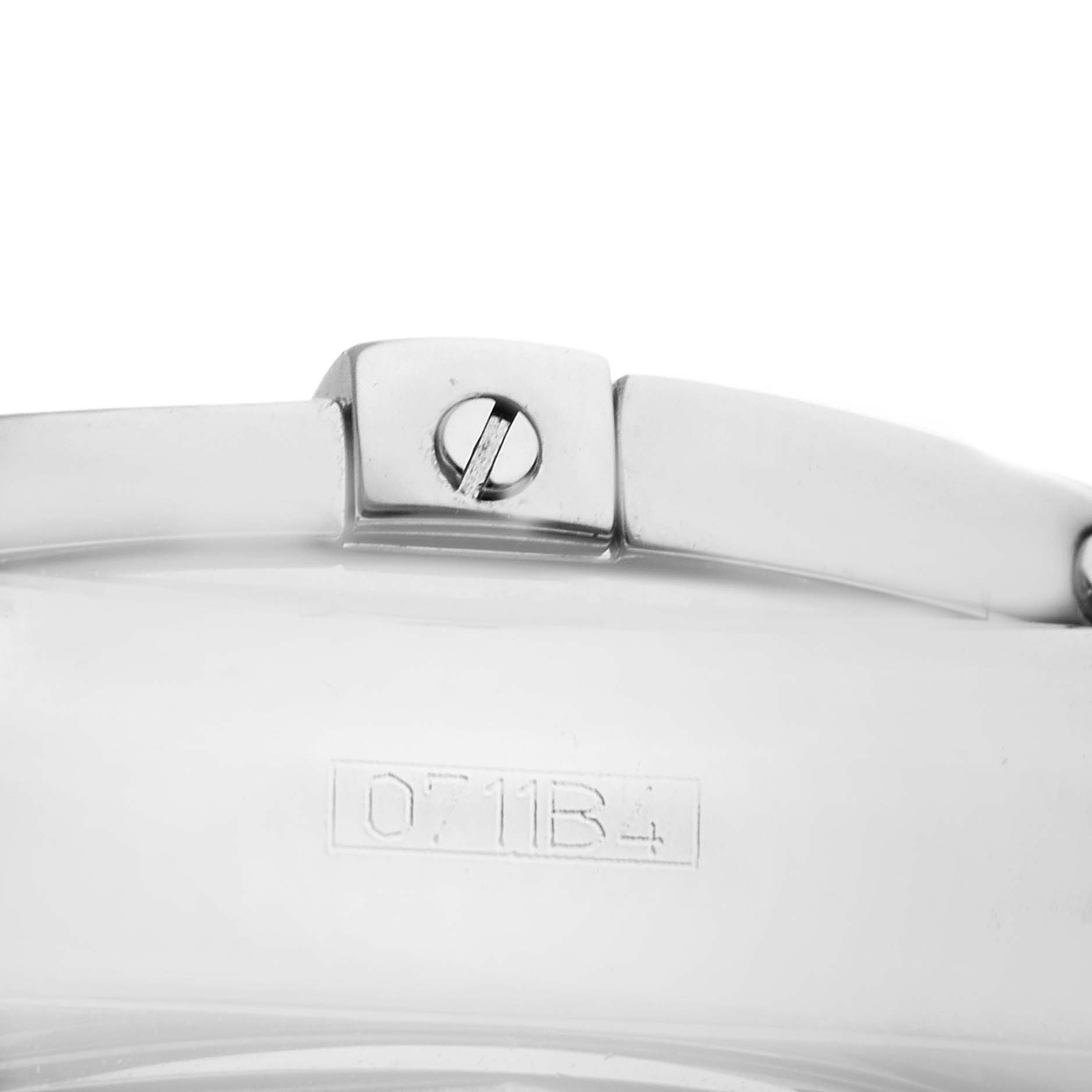 This image shows a close-up of part of the bracelet and clasp on a Breitling Chronomat AB0140 Men's Stainless Steel Mother of Pearl Dial AB0140 Men's Stainless Steel Mother of Pearl Dial watch, including a serial number.