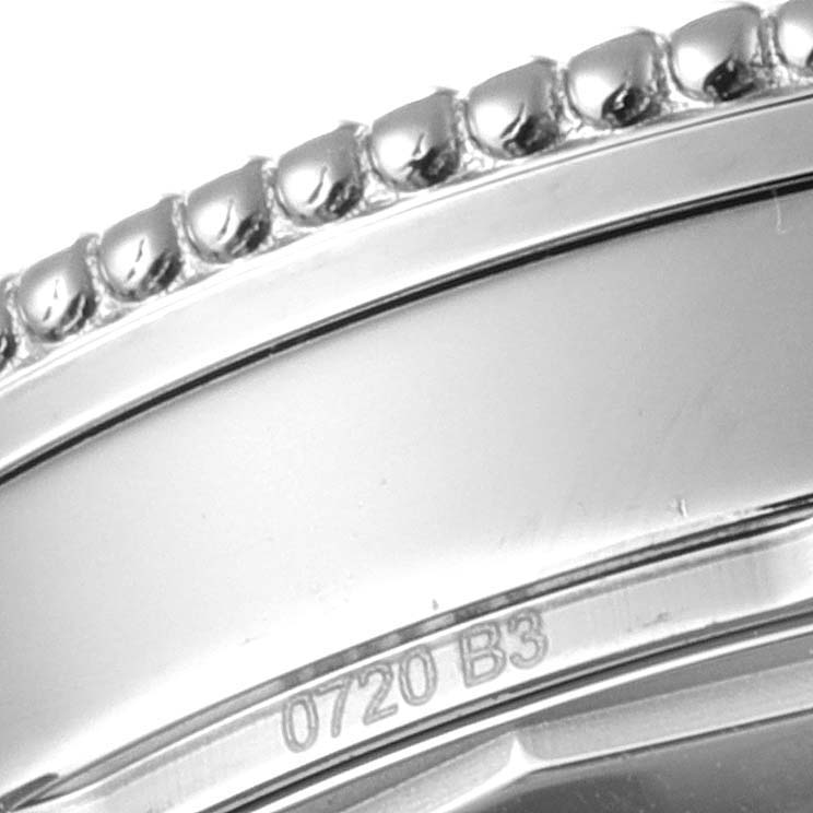 This close-up image shows the bezel and part of the case with serial number inscriptions of a Breitling Navitimer A17326 Men's Stainless Steel Black Dial A17326 Men's Stainless Steel Black Dial watch.